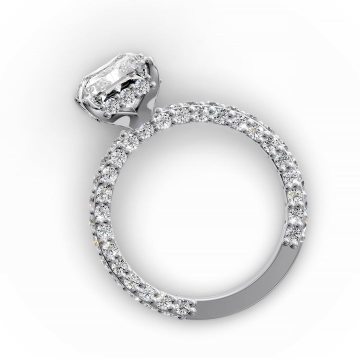 Radiant hidden halo engagement ring with three-row diamond band in studio lighting.