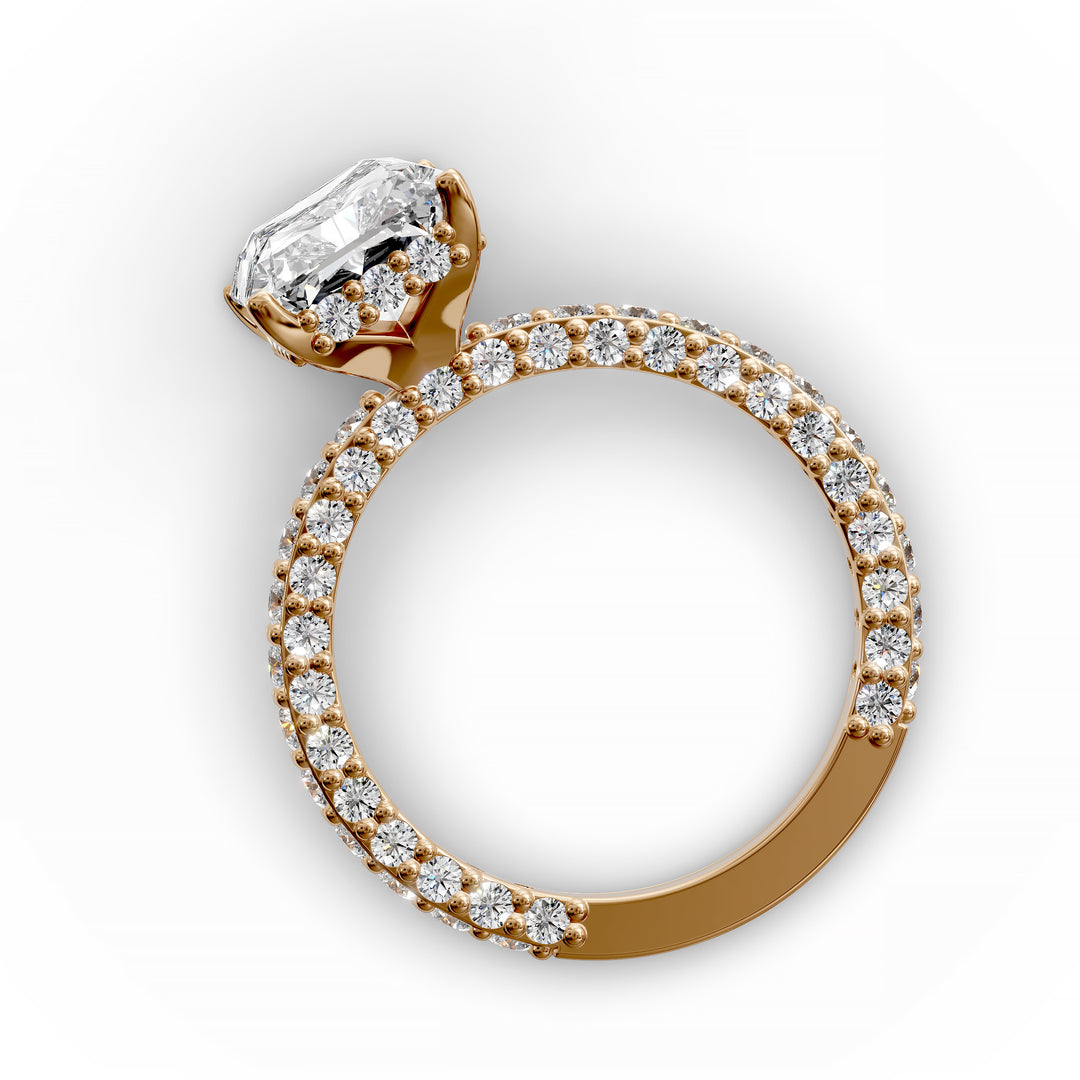 Radiant hidden halo engagement ring with three-row diamond band in studio lighting.