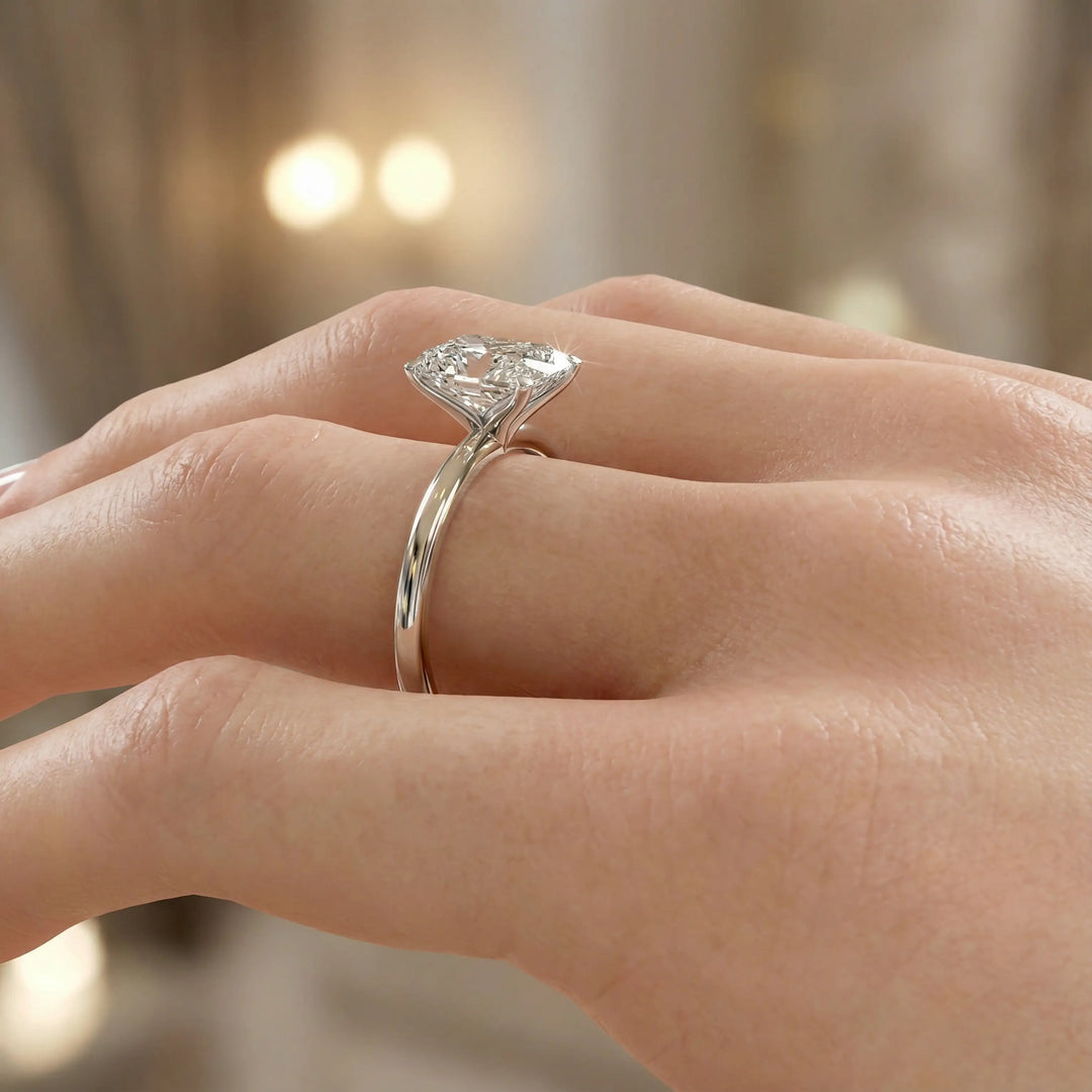 Radiant cut diamond solitaire engagement ring with a classic smooth band shown in display view.