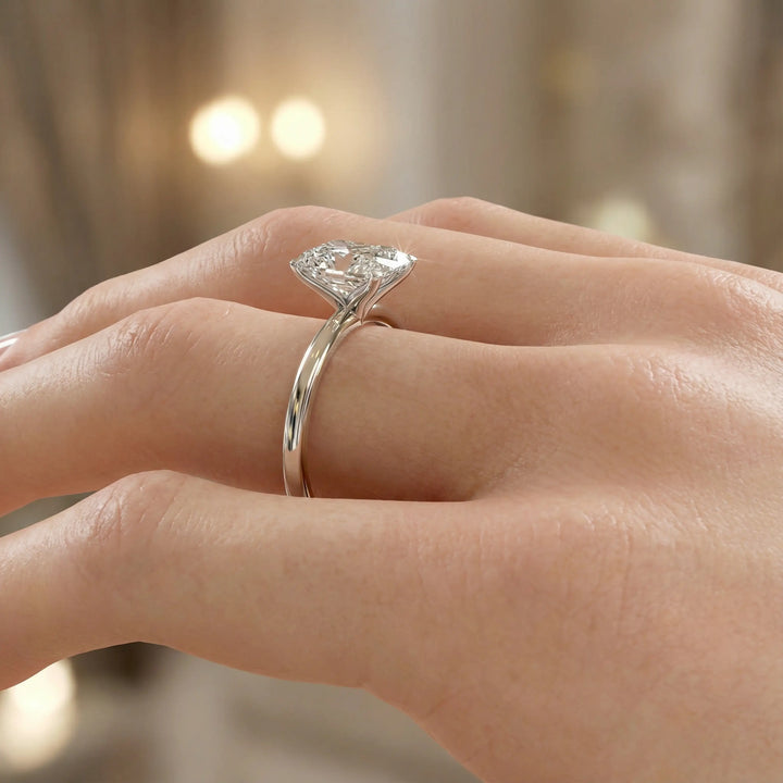 Radiant cut diamond solitaire engagement ring with a classic smooth band shown in display view.