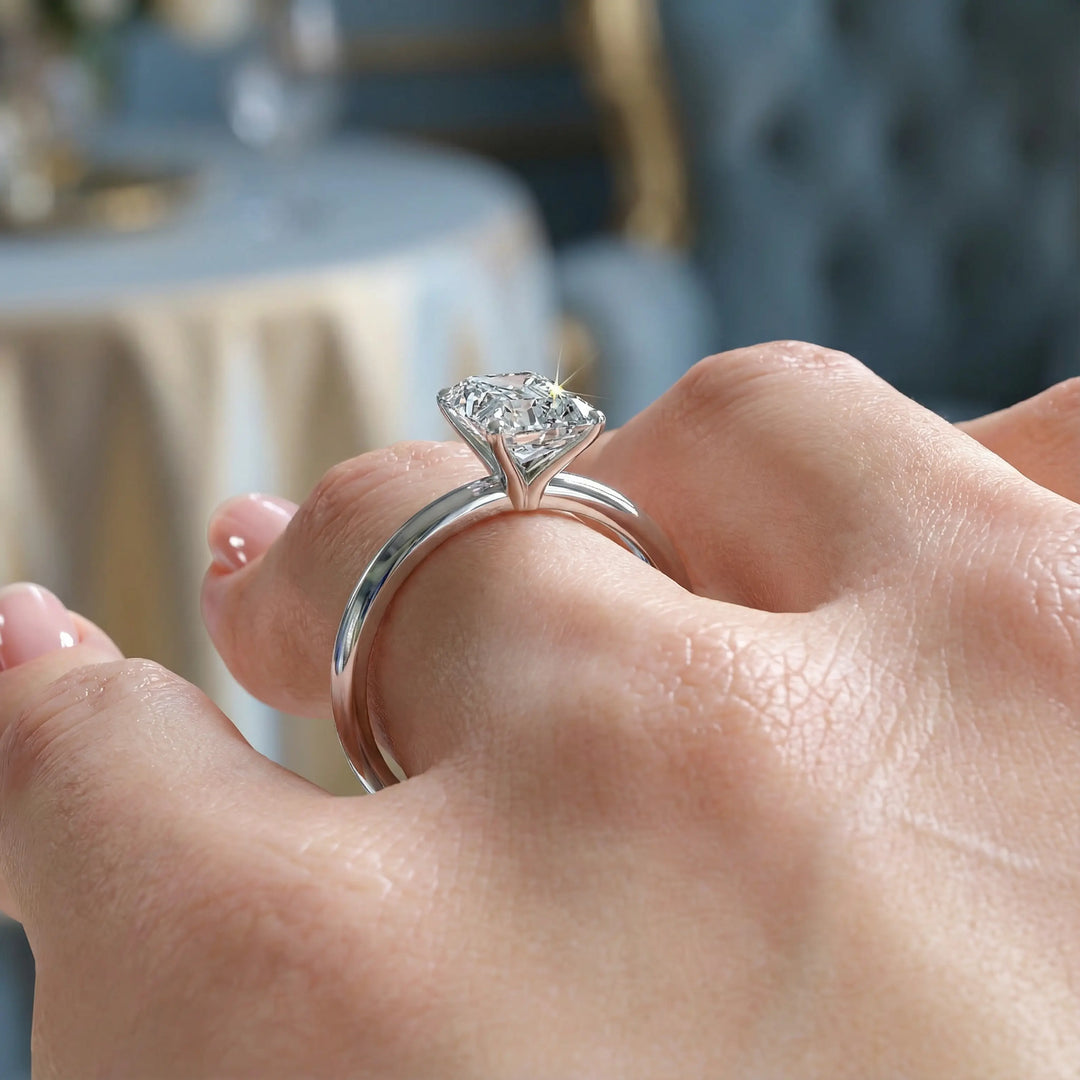 Radiant cut diamond solitaire engagement ring with a classic smooth band shown in display view.