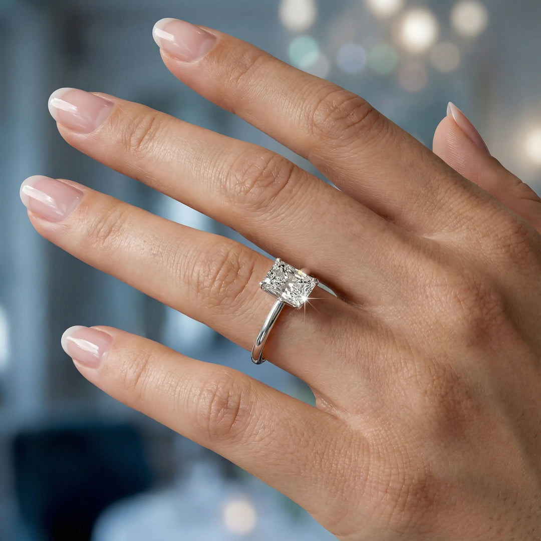 Radiant cut diamond solitaire engagement ring with a classic smooth band shown in display view.