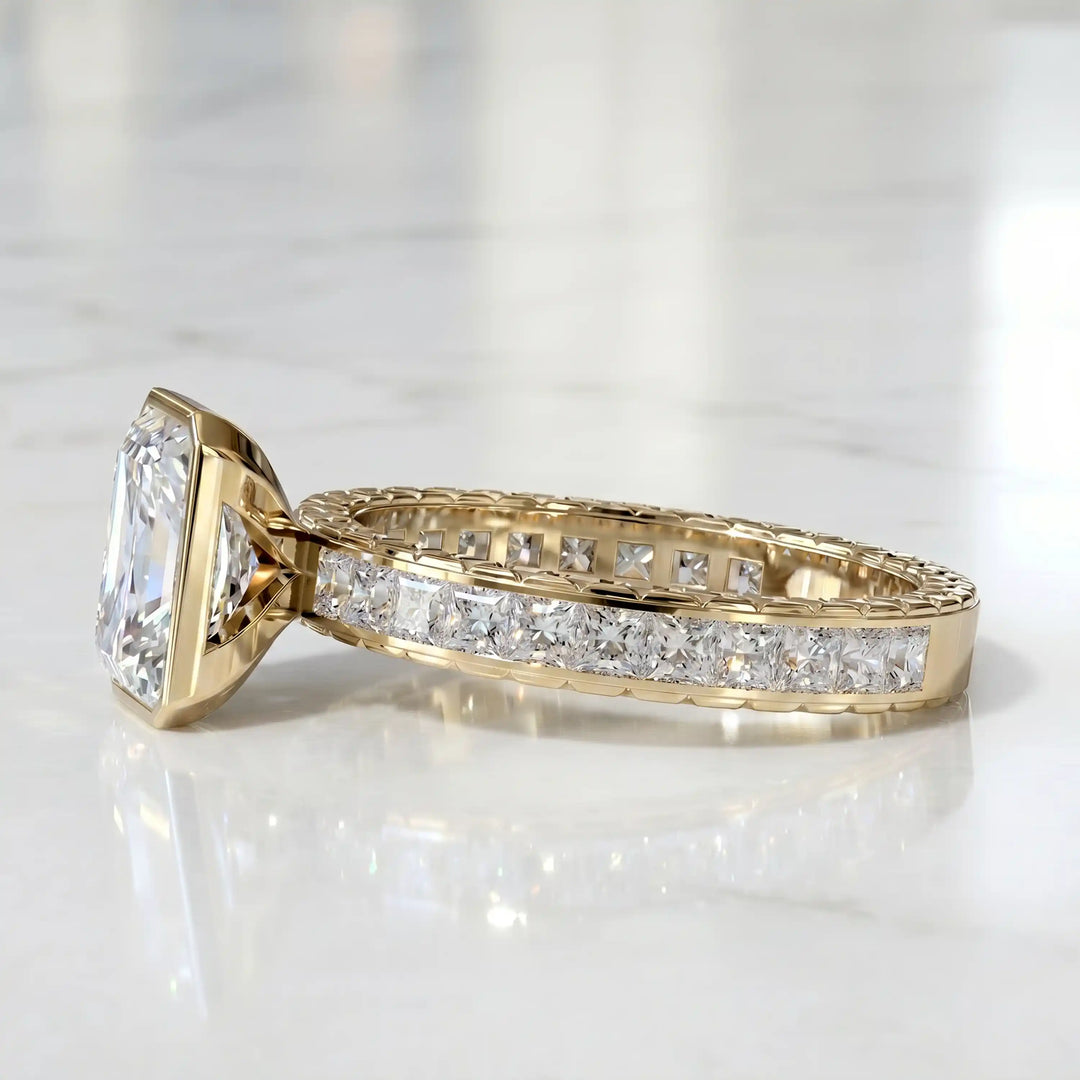 Radiant lab-grown diamond engagement ring with princess cut channel set band on marble display.