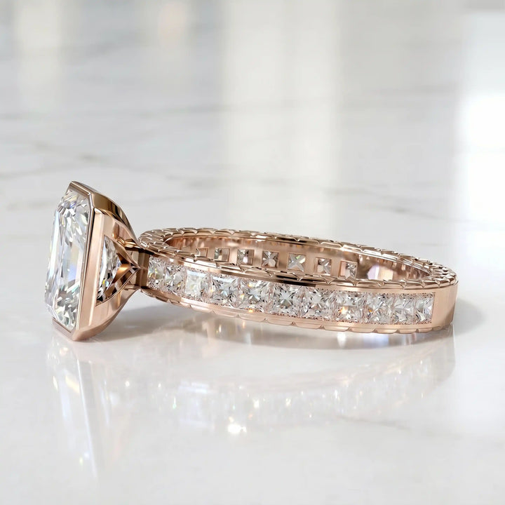 Radiant lab-grown diamond engagement ring with princess cut channel set band on marble display.