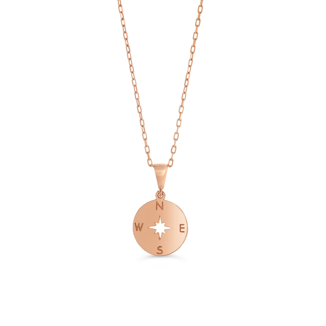 10K rose gold necklace featuring a round compass plate pendant with cardinal directions and a star cutout on a 16″ chain.