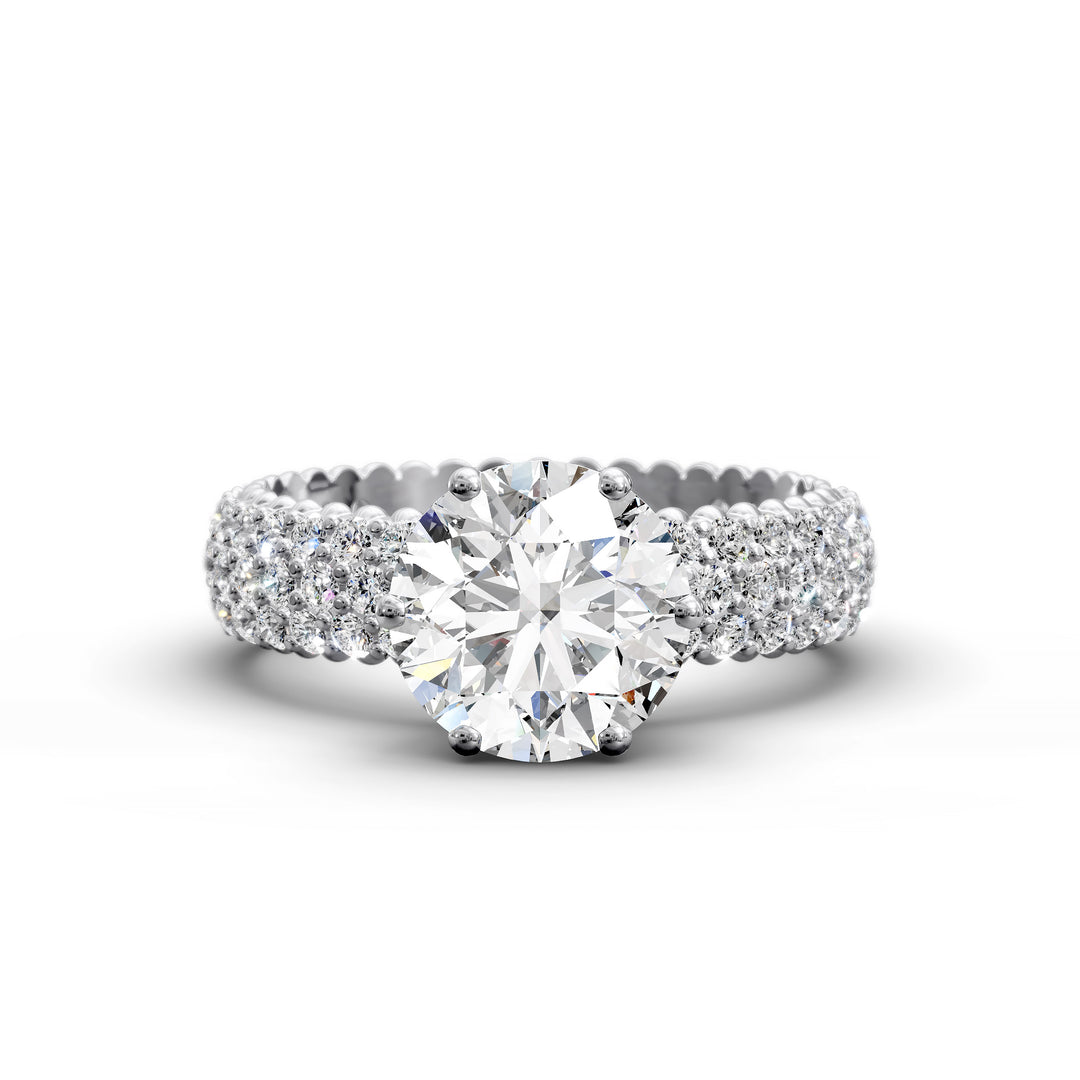 Round diamond engagement ring with six-prong crown setting and multi-row diamond band shown in studio lighting.