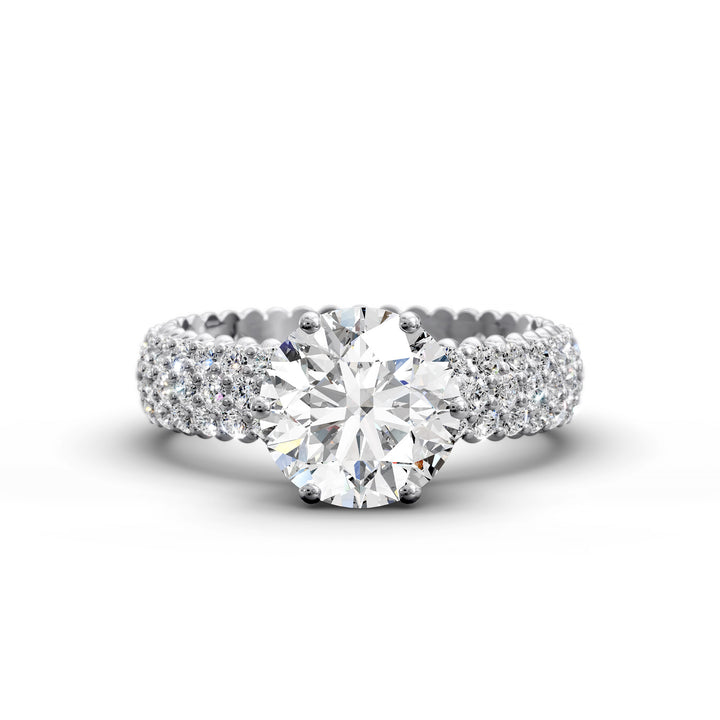 Round diamond engagement ring with six-prong crown setting and multi-row diamond band shown in studio lighting.