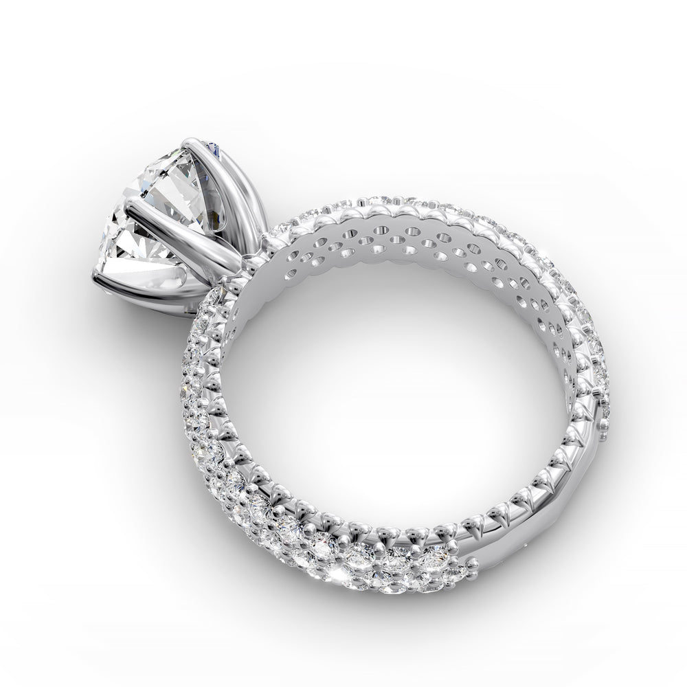 Round diamond engagement ring with six-prong crown setting and multi-row diamond band shown in studio lighting.