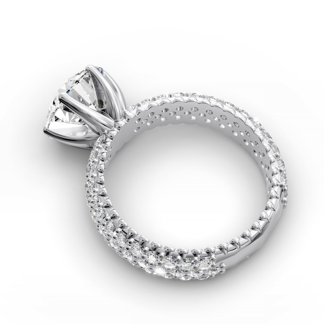 Round diamond engagement ring with six-prong crown setting and multi-row diamond band shown in studio lighting.