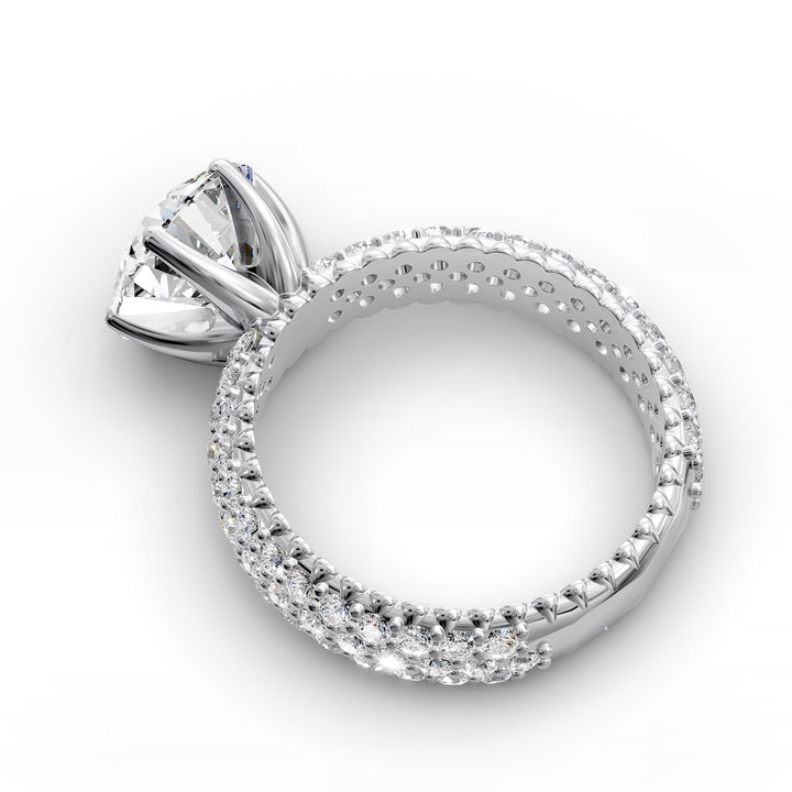 Round diamond engagement ring with six-prong crown setting and multi-row diamond band shown in studio lighting.