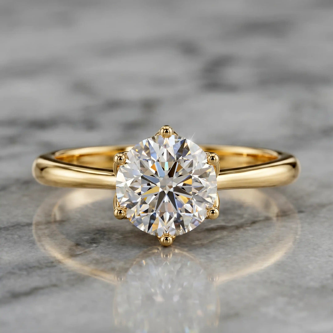 Round lab-grown diamond tulip prong engagement ring shown on marbel.