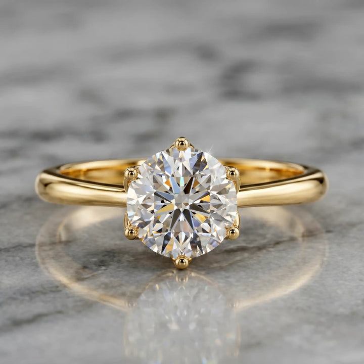 Round lab-grown diamond tulip prong engagement ring shown on marbel.