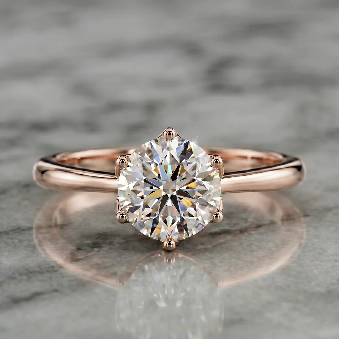 Round lab-grown diamond tulip prong engagement ring shown on marbel.