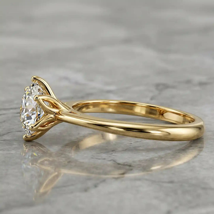 Round lab-grown diamond tulip prong engagement ring shown on marbel.