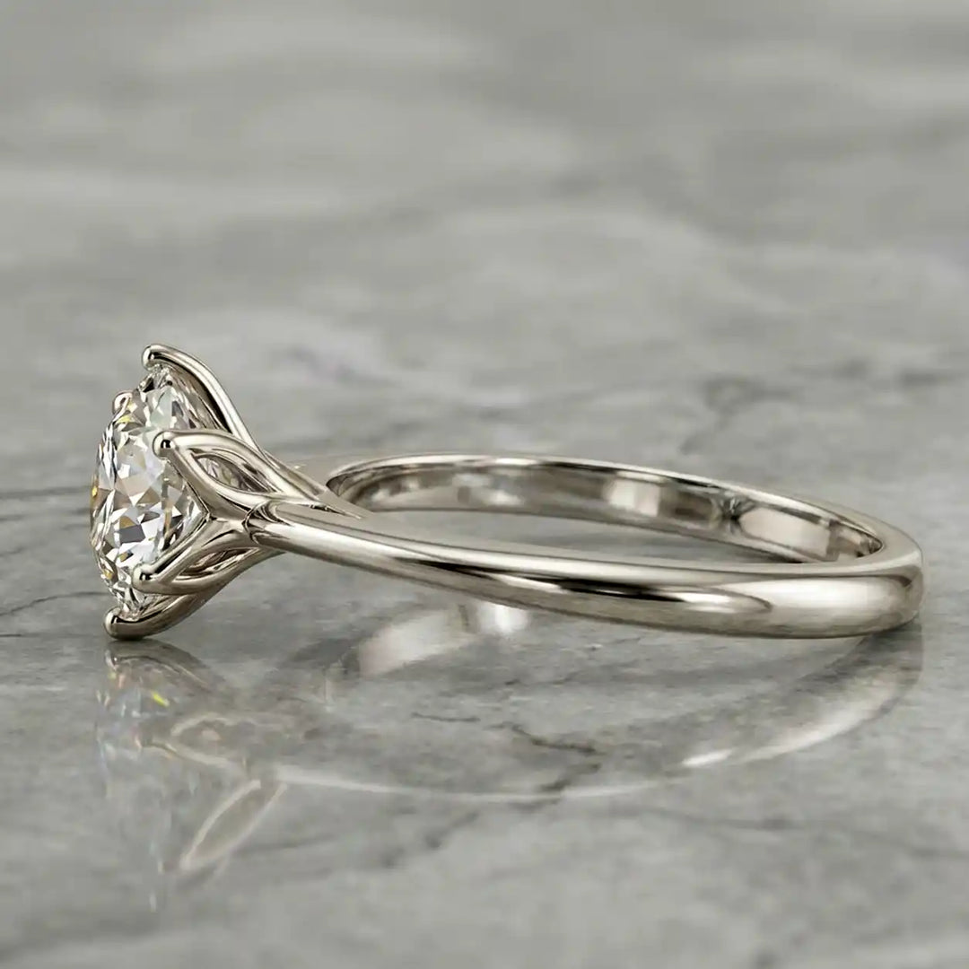 Round lab-grown diamond tulip prong engagement ring shown on marbel.