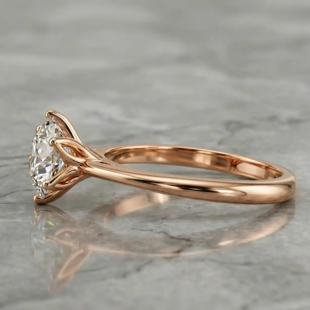 Round lab-grown diamond tulip prong engagement ring shown on marbel.