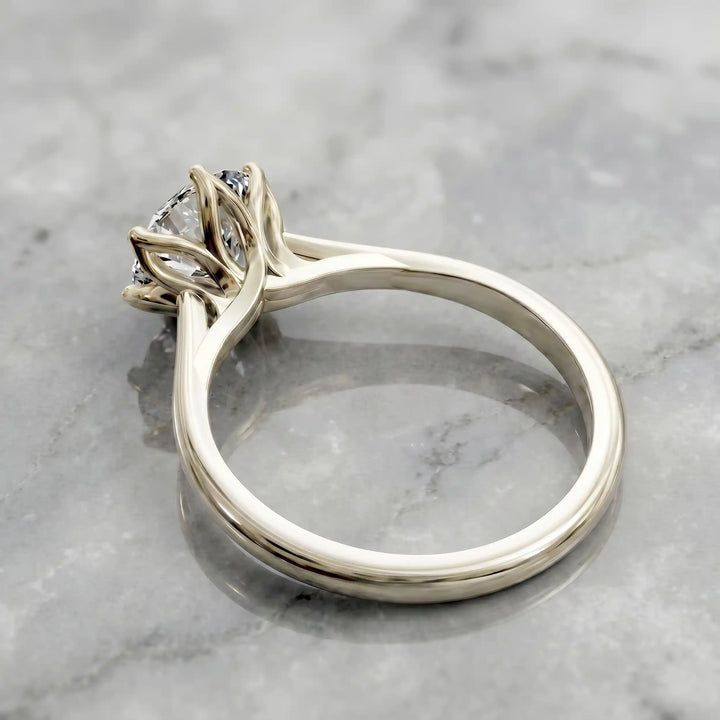 Round lab-grown diamond tulip prong engagement ring shown on marbel.