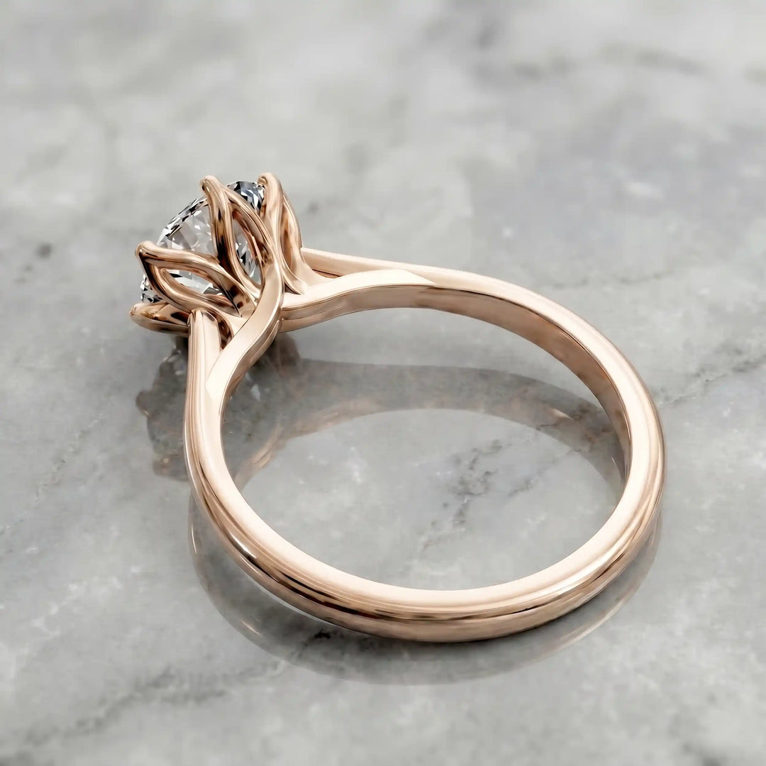 Round lab-grown diamond tulip prong engagement ring shown on marbel.