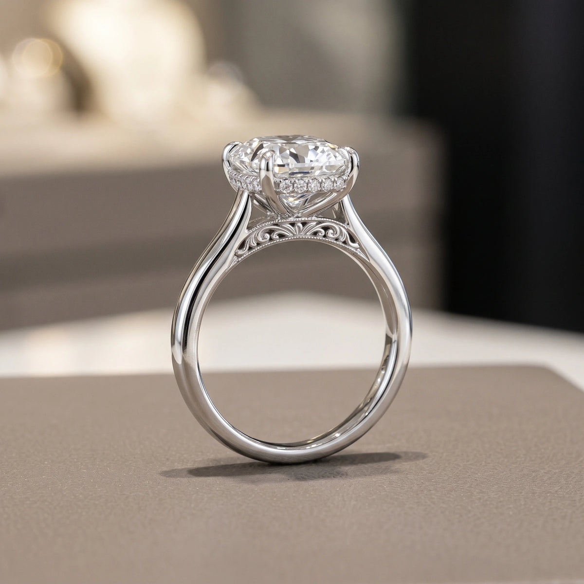 Side view of a platinum cushion-cut diamond engagement ring with a hidden halo, cathedral shoulders and an ornate bridge