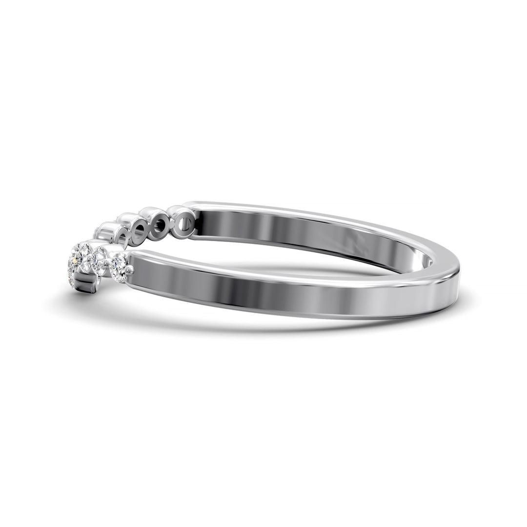 V-shaped gold wedding band with shared prong floating diamonds