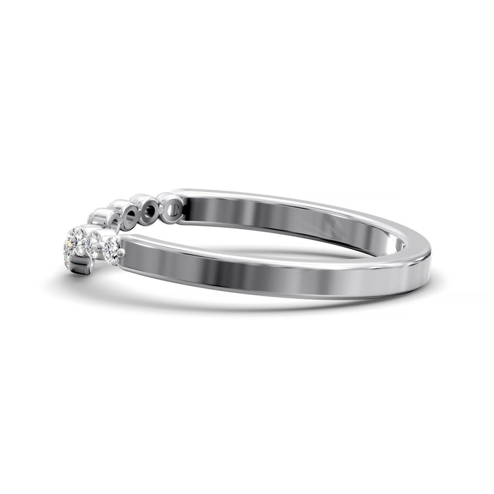 V-shaped gold wedding band with shared prong floating diamonds