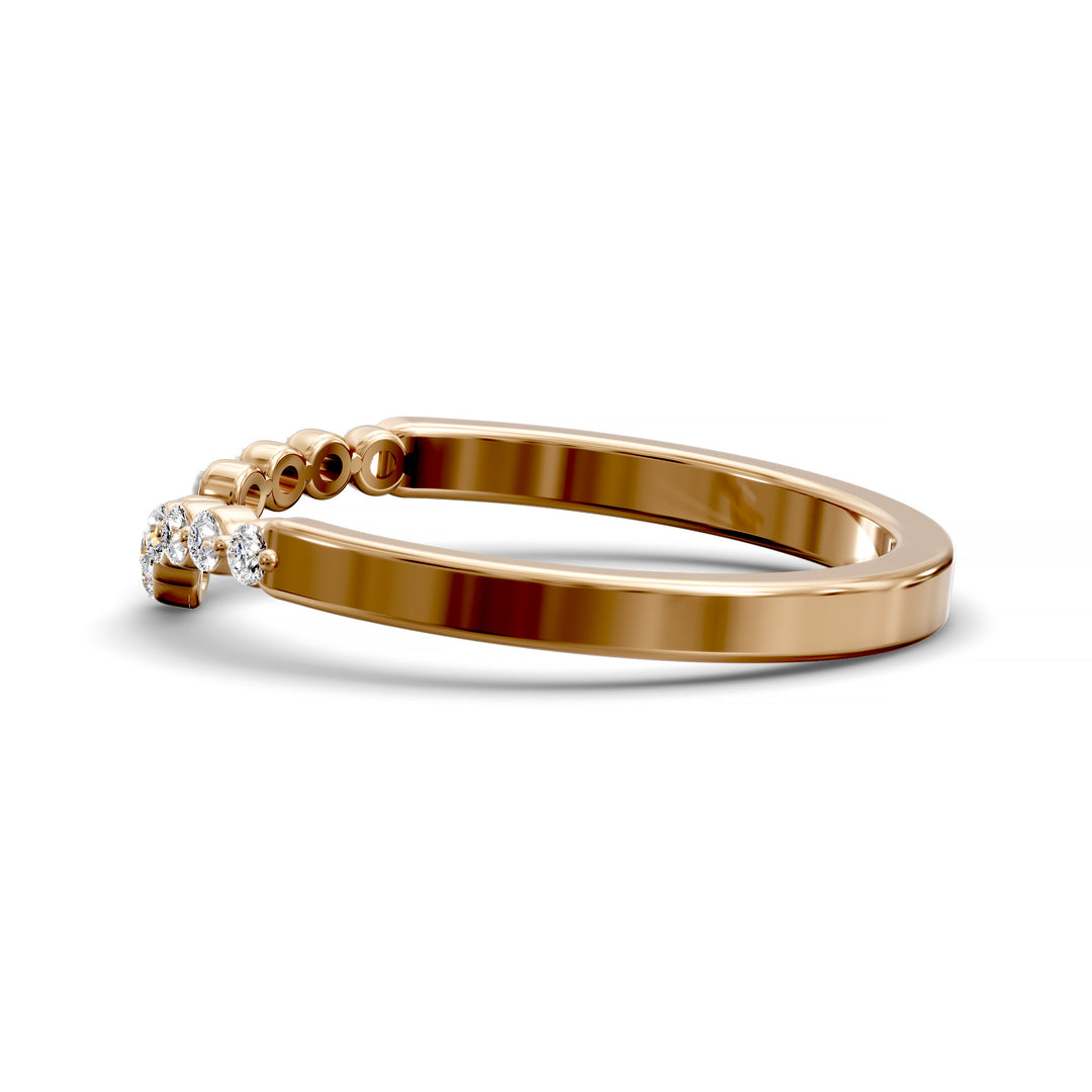 V-shaped gold wedding band with shared prong floating diamonds