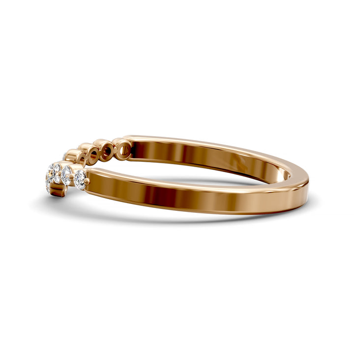 V-shaped gold wedding band with shared prong floating diamonds
