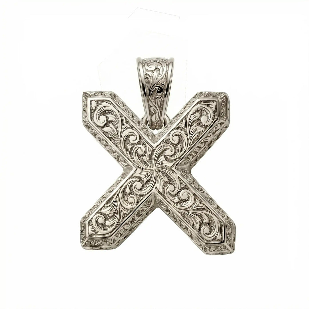 St. Andrew diagonal cross pendant with engraved ornamental design displayed on white background.