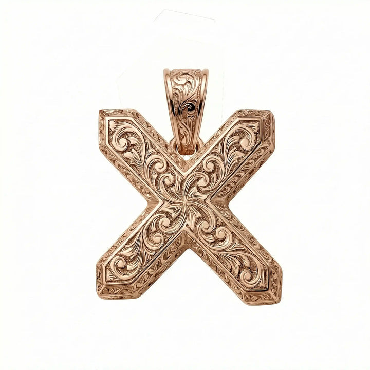 St. Andrew diagonal cross pendant with engraved ornamental design displayed on white background.