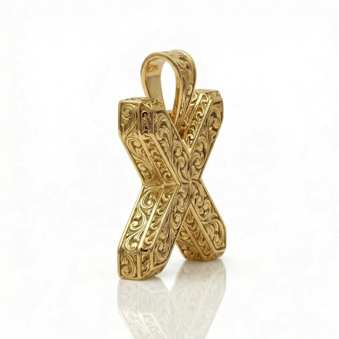 St. Andrew diagonal cross pendant with engraved ornamental design displayed on white background.