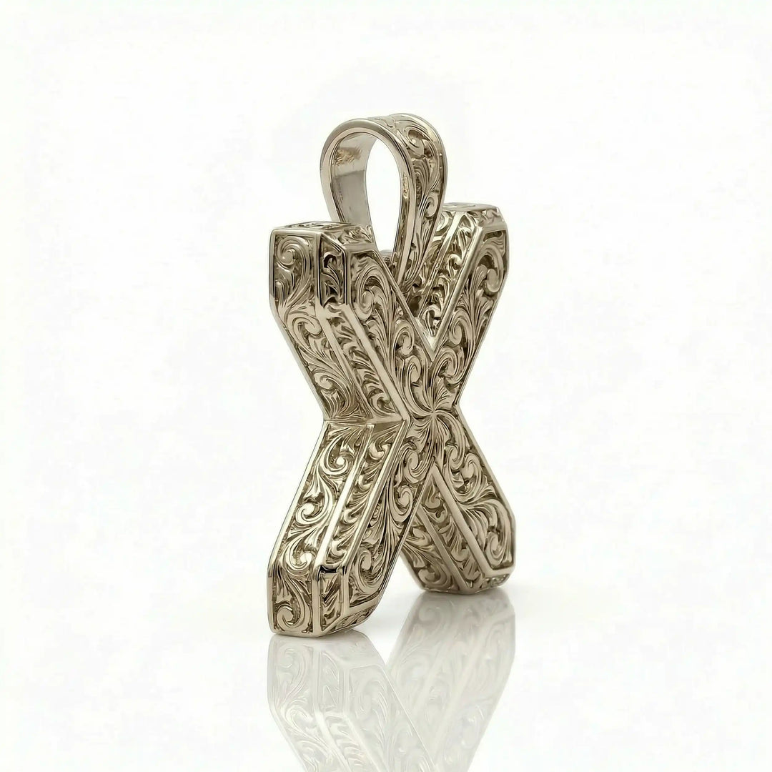 St. Andrew diagonal cross pendant with engraved ornamental design displayed on white background.