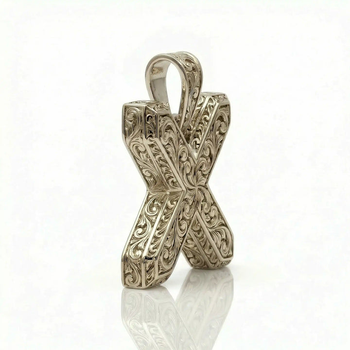 St. Andrew diagonal cross pendant with engraved ornamental design displayed on white background.