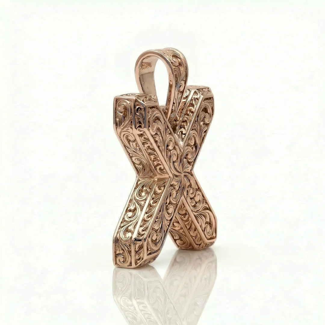 St. Andrew diagonal cross pendant with engraved ornamental design displayed on white background.