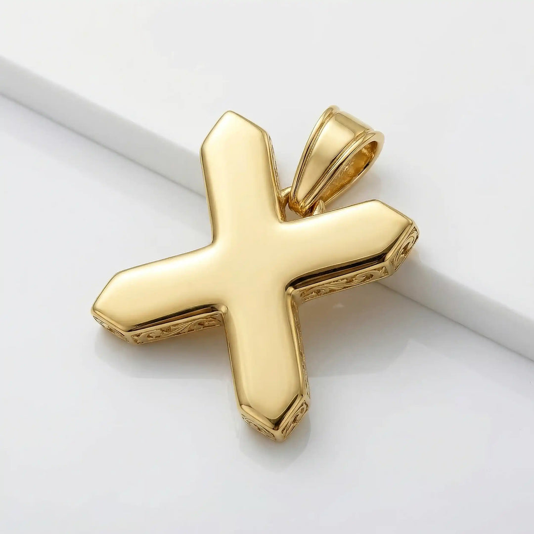 St. Andrew diagonal cross pendant with engraved ornamental design displayed on white background.