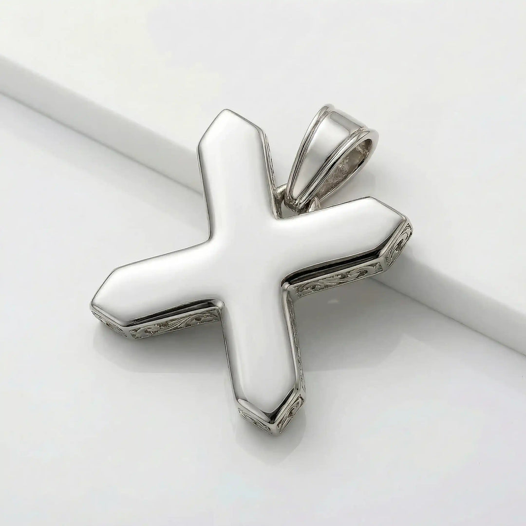 St. Andrew diagonal cross pendant with engraved ornamental design displayed on white background.