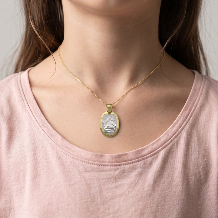 Two-Tone Gold Angel Medal worn on a model's neck on a fine chain
