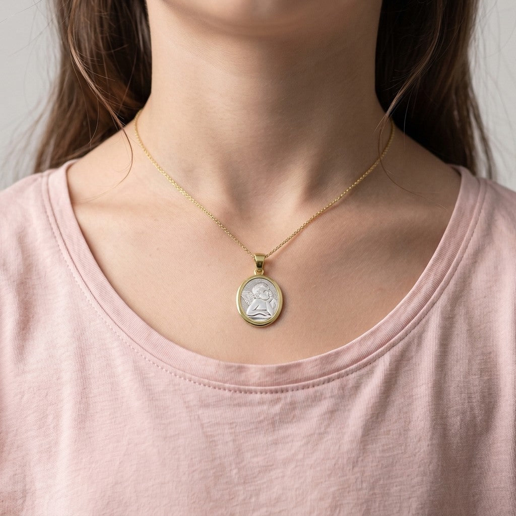 Two-Tone Gold Angel Medal worn on a model's neck on a fine chain