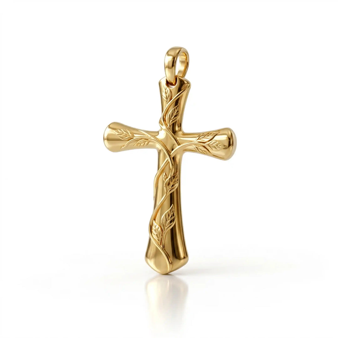Vine cross pendant with engraved leaf detail displayed on white background.