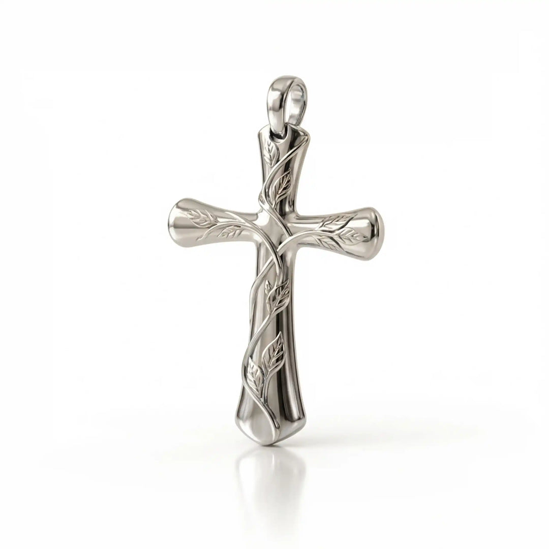 Vine cross pendant with engraved leaf detail displayed on white background.