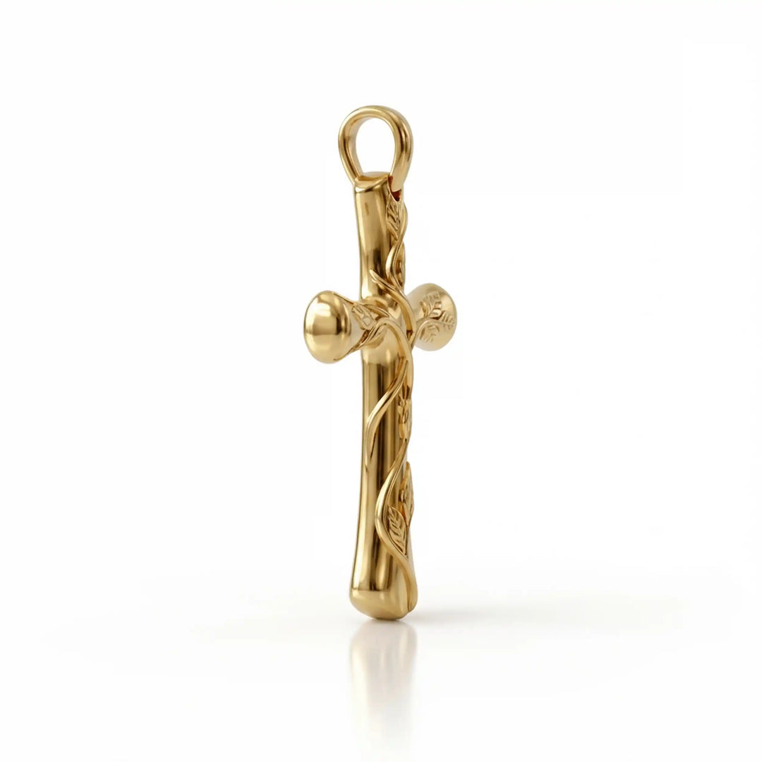 Vine cross pendant with engraved leaf detail displayed on white background.