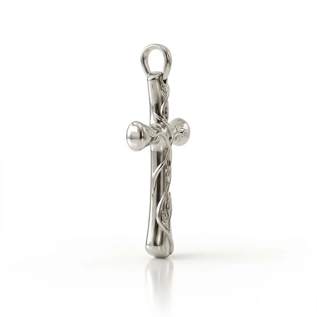 Vine cross pendant with engraved leaf detail displayed on white background.