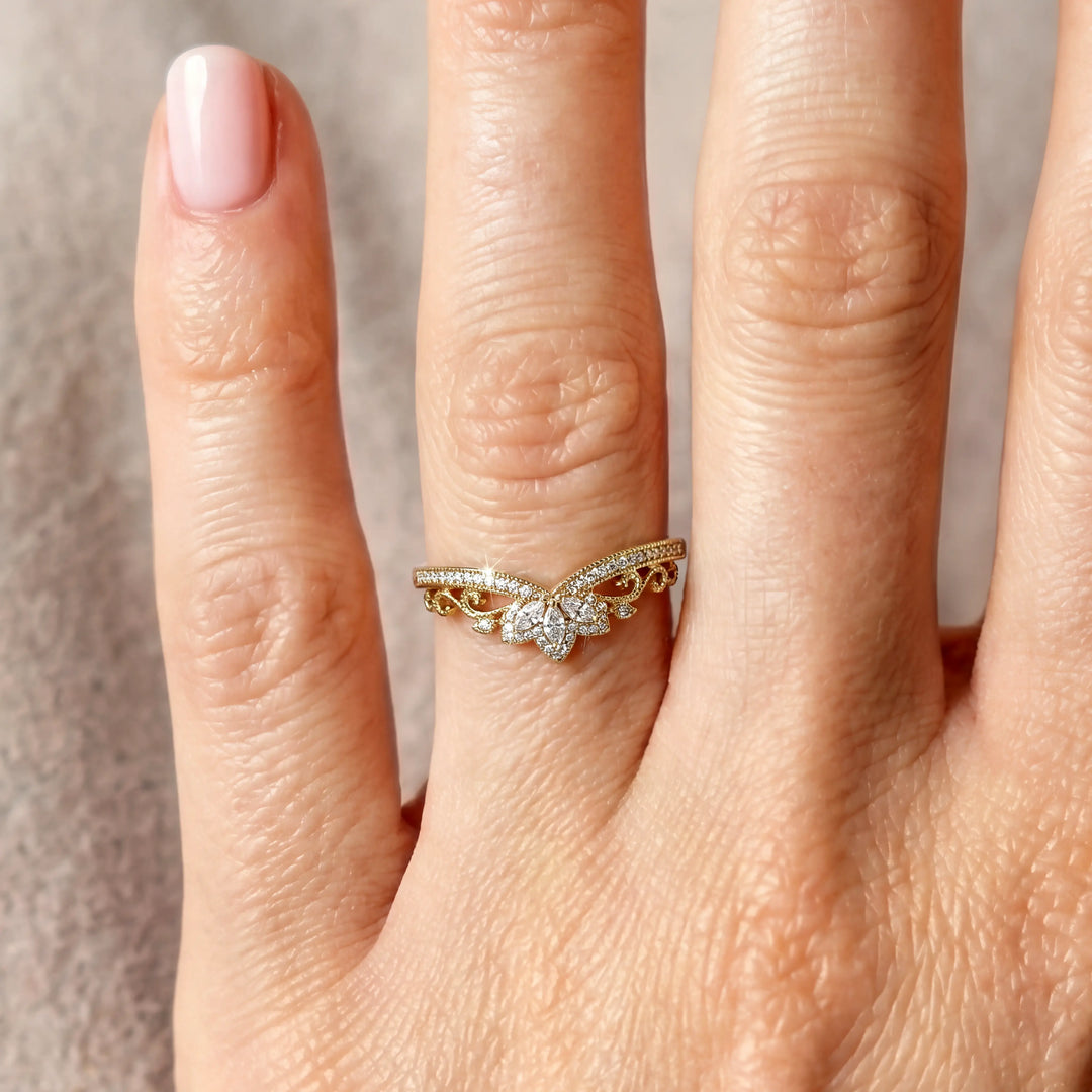 Vintage marquise floral lab-grown diamond wedding band with pavé accents on hand.