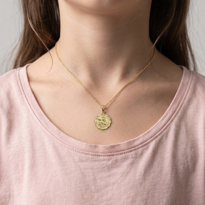Yellow Gold Angel Medal worn on a model's neck on a fine chain